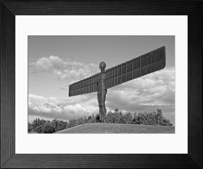 Framed Print : The landmark iconic Angel of the North statue in Gateshead, Tyne and Wear. Captured in golden light to contract the rust colour against cloudy blue sk Framed Print : The landmark iconic Angel of the North statue in Gateshead, Tyne and Wear. Captured in golden light to contract the rust colour against cloudy blue sk