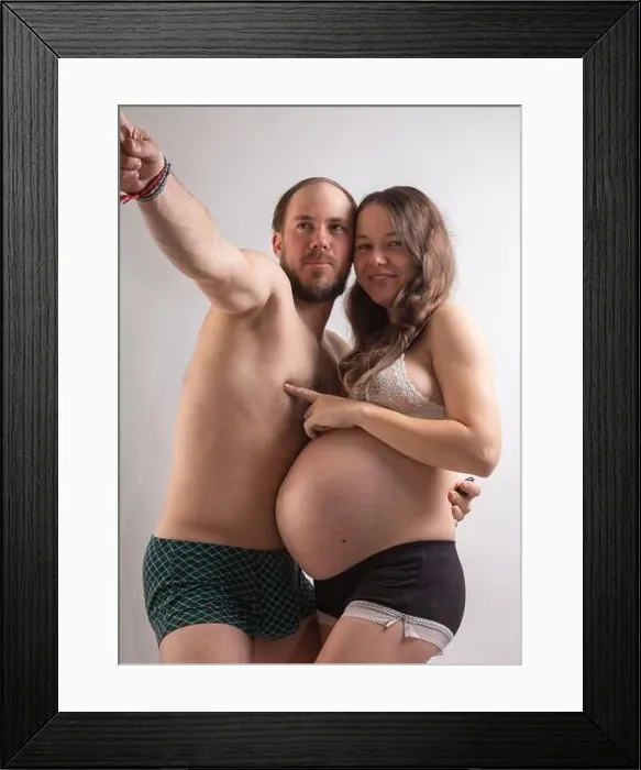 Framed Print : Beautiful pregnant woman and her handsome husband are kissing while spending time together in bed Framed Print : Beautiful pregnant woman and her handsome husband are kissing while spending time together in bed