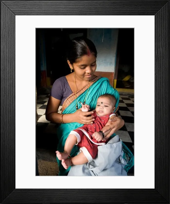 Framed Print : Young Indian mother with her son in her house at the fisherman village in Puri, Orissa, India Framed Print : Young Indian mother with her son in her house at the fisherman village in Puri, Orissa, India