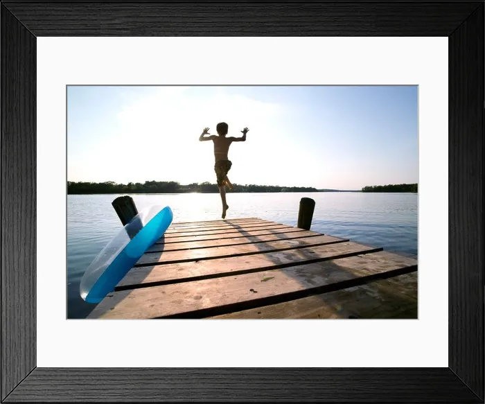Framed Print : Kid jumping off a dock into a Lake Framed Print : Kid jumping off a dock into a Lake