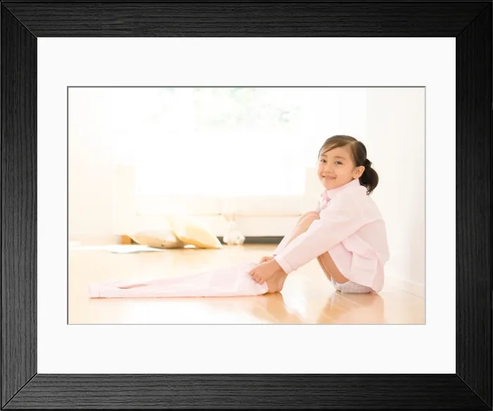 Framed Print : Girl putting on pajama pants Framed Print : Girl putting on pajama pants