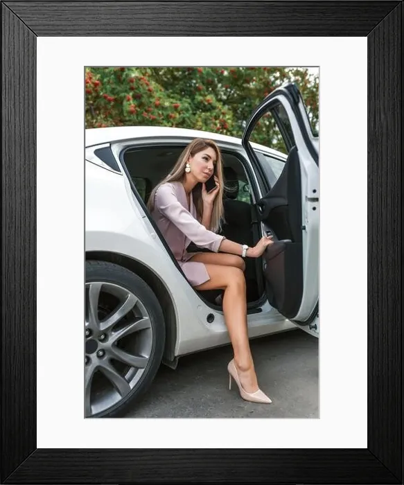 Framed Print : business woman leaves car, taxi rental, car sharing, calling ordering business VIP taxi, calls on her smartphone, listens voice message. In summer Framed Print : business woman leaves car, taxi rental, car sharing, calling ordering business VIP taxi, calls on her smartphone, listens voice message. In summer