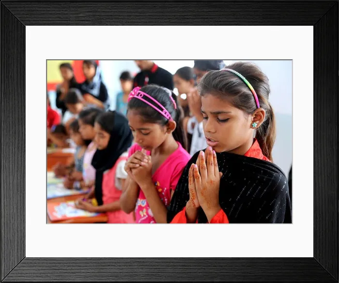 Framed Print : Children praying before religious education in a classroom of a school in Karachi, Pakistan Framed Print : Children praying before religious education in a classroom of a school in Karachi, Pakistan