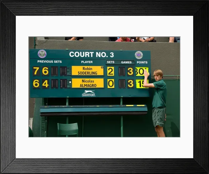 Framed Print : The Court 3 scoreboard is changed during the 2009 Wimbledon Tennis Championships