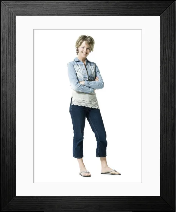 Framed Print : Portrait of a young woman standing and smiling Framed Print : Portrait of a young woman standing and smiling