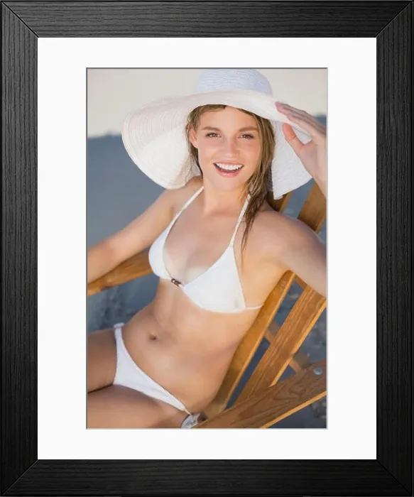 Framed Print : Smiling woman in straw hat relaxing in deck chair on the beach on a sunny day Framed Print : Smiling woman in straw hat relaxing in deck chair on the beach on a sunny day