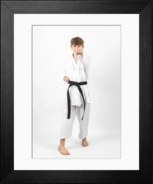 Framed Print : A 15 year old Karate Blackbelt boy, wearing A Gi performing a punch Framed Print : A 15 year old Karate Blackbelt boy, wearing A Gi performing a punch