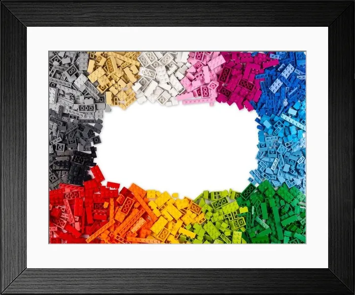 Framed Print : top view of frame of many various colorful rainbow colored stackable plastic toy bricks with copy space isolated on white background