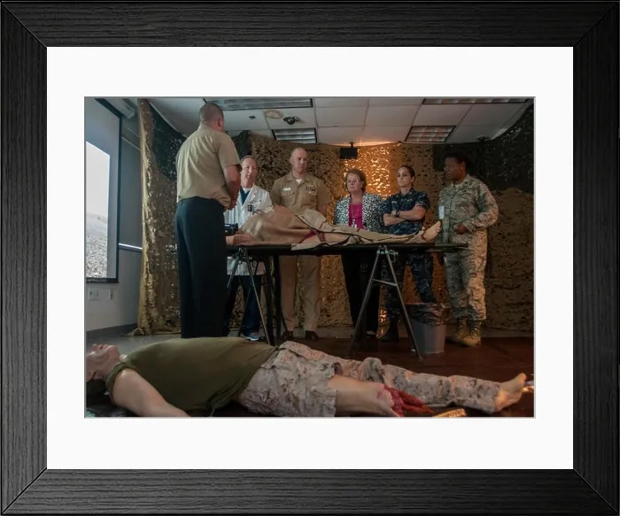 Framed Print : HM2 (FMF / SW / EXW / CAC) Patrick Gravel speaks to visitors about the combat simulators that train healthcare providers to respond to battlefield trauma Framed Print : HM2 (FMF / SW / EXW / CAC) Patrick Gravel speaks to visitors about the combat simulators that train healthcare providers to respond to battlefield trauma