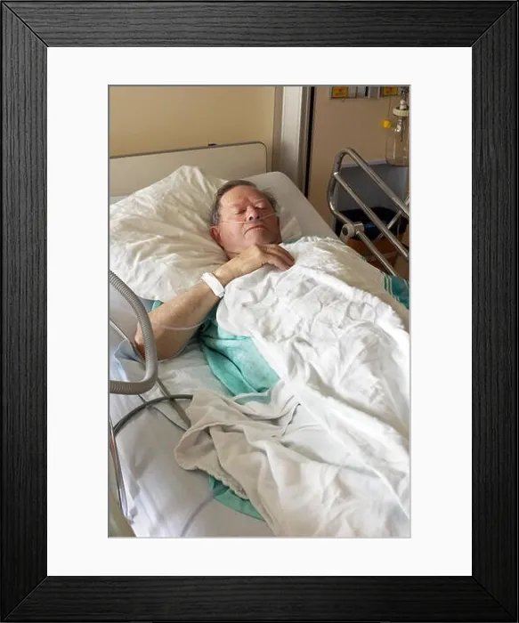 Framed Print : Senior man lying in hospital bed getting oxygen in intensive care unit, vertical Framed Print : Senior man lying in hospital bed getting oxygen in intensive care unit, vertical