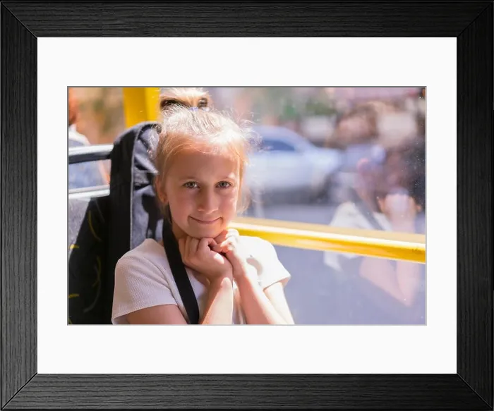 Framed Print : A little girl is going by bus. Schoolgirl sitting in school bus and ready for her first ride Framed Print : A little girl is going by bus. Schoolgirl sitting in school bus and ready for her first ride
