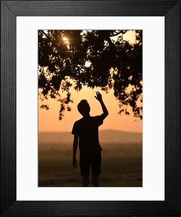 Framed Print : Closeup portrait young man praying hands up at sunset Framed Print : Closeup portrait young man praying hands up at sunset