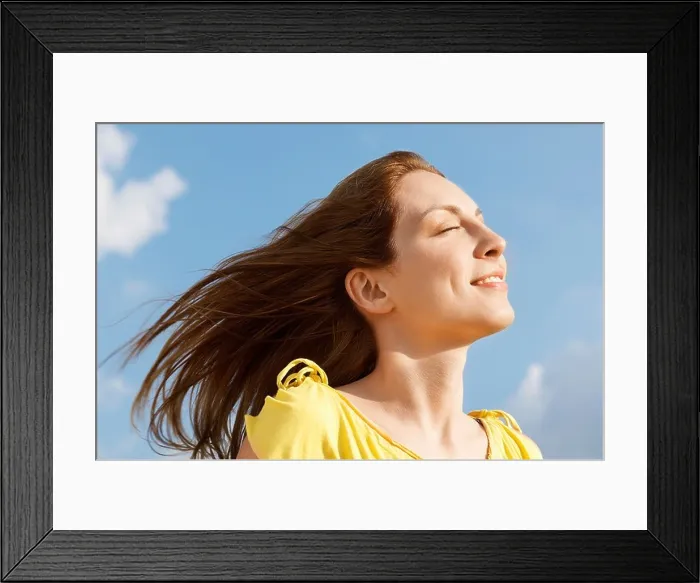 Framed Print : Young woman outdoors enjoying wind on face, close up Framed Print : Young woman outdoors enjoying wind on face, close up
