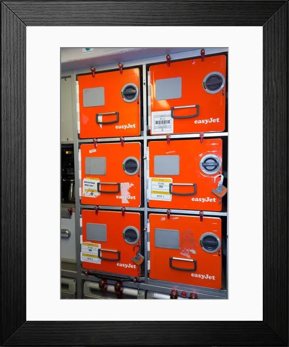 Framed Print : Aluminium food / meal storage locker / lockers / box / canister boxes in the galley on an easyet Airbus A320 or A319 aircraft during a short haul Framed Print : Aluminium food / meal storage locker / lockers / box / canister boxes in the galley on an easyet Airbus A320 or A319 aircraft during a short haul