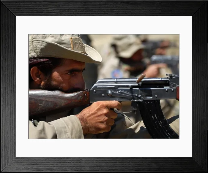 Framed Print : An Afghan security guard, assigned to Forward Operating Base Torkham, fires an AK-47 assault rifle during a weapons range hosted by the 527th Framed Print : An Afghan security guard, assigned to Forward Operating Base Torkham, fires an AK-47 assault rifle during a weapons range hosted by the 527th