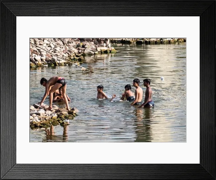 Framed Print : Bhopal, Madhya Pradesh, India - March 2019: Young Indian teenage boys swimming and bathing in the waters of the Upper Lake in the city of Bhopal Framed Print : Bhopal, Madhya Pradesh, India - March 2019: Young Indian teenage boys swimming and bathing in the waters of the Upper Lake in the city of Bhopal