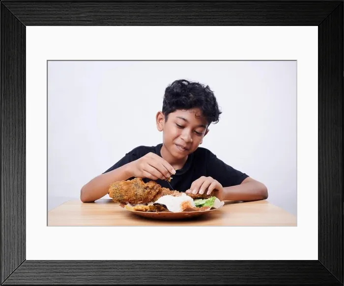 Framed Print : Little Boy eating Fried Fish and rice at home Framed Print : Little Boy eating Fried Fish and rice at home