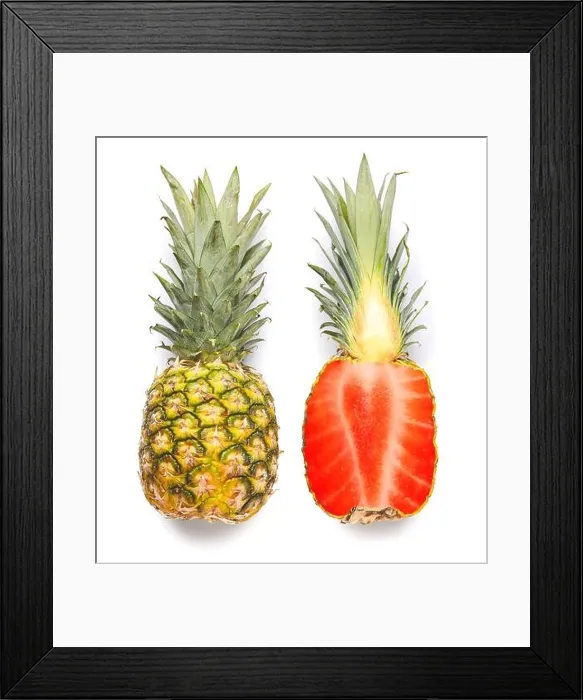 Framed Print : Cut pineapple with strawberry inside on white background. Concept of photo manipulations and GMO Framed Print : Cut pineapple with strawberry inside on white background. Concept of photo manipulations and GMO