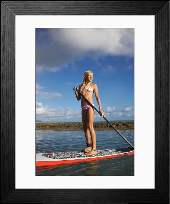 Framed Print : A pre-teen girl at Paia Beach, Maui, Hawaii stand-up paddling her surf board Framed Print : A pre-teen girl at Paia Beach, Maui, Hawaii stand-up paddling her surf board