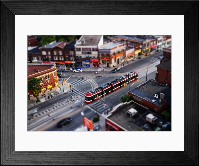 Framed Print : Toronto streetcar passing through intersection, tilt shift effect Framed Print : Toronto streetcar passing through intersection, tilt shift effect