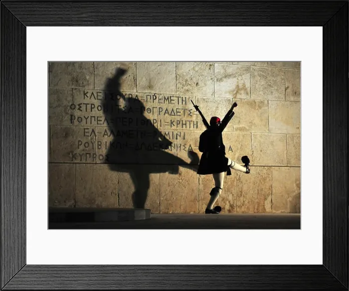 Framed Print : An Evzones soldier in traditional uniform performs an elaborate martial marching routine during the Sunday evening Framed Print : An Evzones soldier in traditional uniform performs an elaborate martial marching routine during the Sunday evening