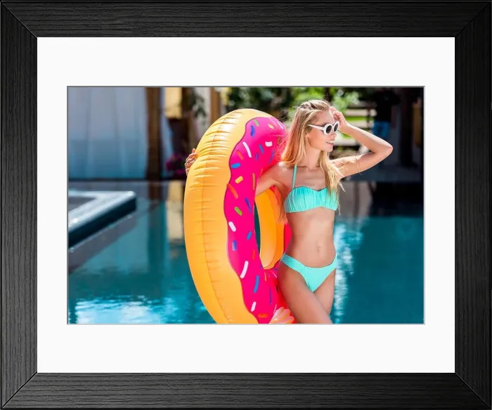 Framed Print : attractive young woman inflatable ring in shape of donut at poolside Framed Print : attractive young woman inflatable ring in shape of donut at poolside