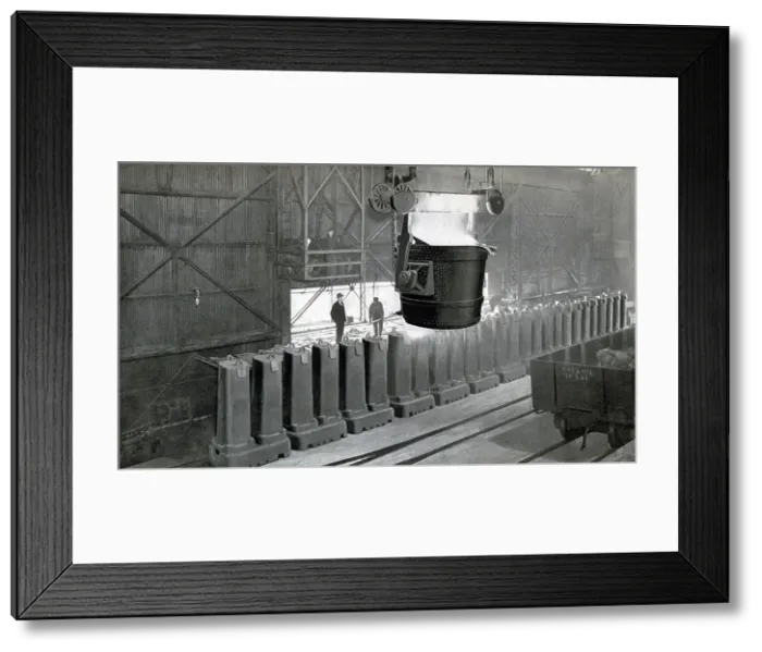 Framed Print : This early 1900s photo shows an Inland Steel company workers at the process of pouring the ingots Framed Print : This early 1900s photo shows an Inland Steel company workers at the process of pouring the ingots