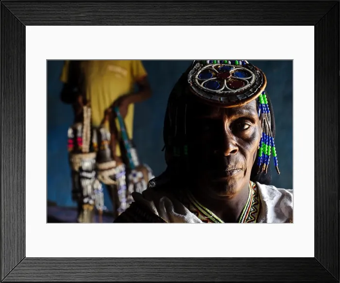 Framed Print : Guji woman in traditional dress + decorated water containers in the background ( Ethiopia) Framed Print : Guji woman in traditional dress + decorated water containers in the background ( Ethiopia)