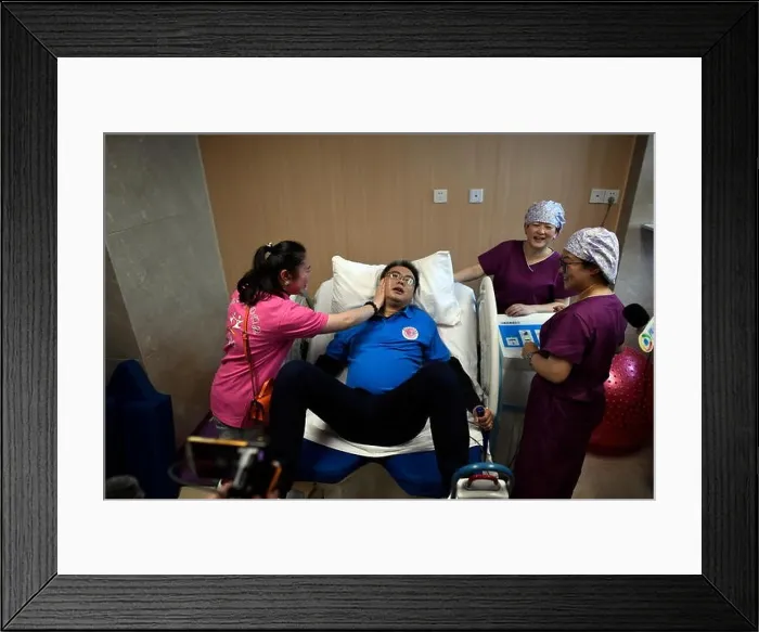 Framed Print : A man goes through labor pain at a hospital in Chongqing Framed Print : A man goes through labor pain at a hospital in Chongqing