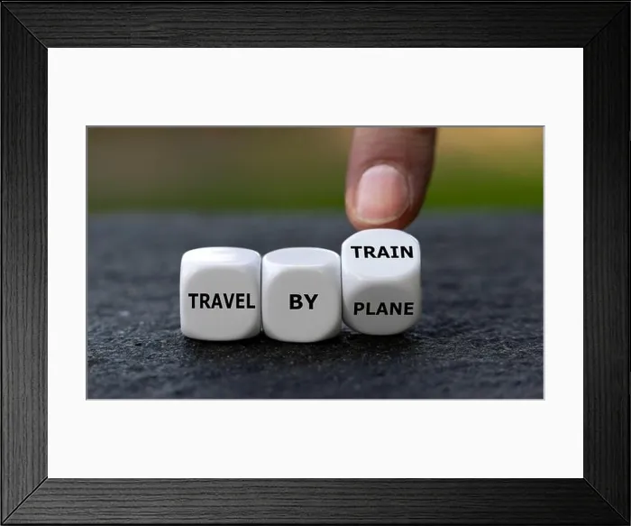 Framed Print : Hand turns dice and changes the expression travel by plane to travel by train Framed Print : Hand turns dice and changes the expression travel by plane to travel by train
