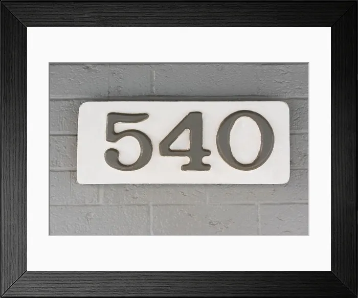 Framed Print : Building number five hundred and forty (540) on a white plaque against a grey brick wall Framed Print : Building number five hundred and forty (540) on a white plaque against a grey brick wall
