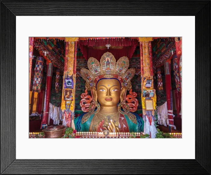 Framed Print : The top half of a gold statue of Buddha is seen from the colourful top floor of a temple in Thiksey Monastery in Ladakh Framed Print : The top half of a gold statue of Buddha is seen from the colourful top floor of a temple in Thiksey Monastery in Ladakh