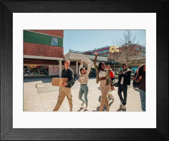 Framed Print : Happy multiracial friends waving hands while walking at street on sunny day