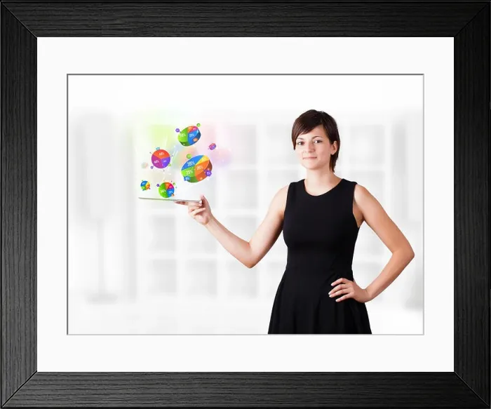Framed Print : Young woman looking at modern tablet with pie charts Framed Print : Young woman looking at modern tablet with pie charts