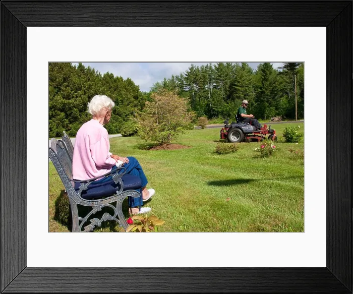 Framed Print : Lawn care service mowing elderly woman's lawn while she watches Framed Print : Lawn care service mowing elderly woman's lawn while she watches