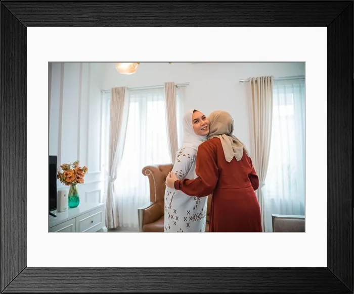 Framed Print : Asian Muslim woman in hijab visiting and embracing during Eid Framed Print : Asian Muslim woman in hijab visiting and embracing during Eid