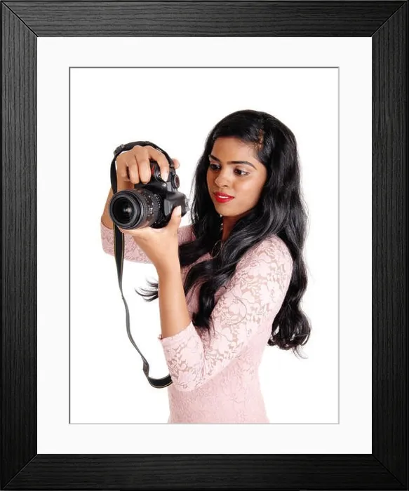 Framed Print : A young beautiful Indian women taking pictures with a DLS camera, isolated for white background Framed Print : A young beautiful Indian women taking pictures with a DLS camera, isolated for white background