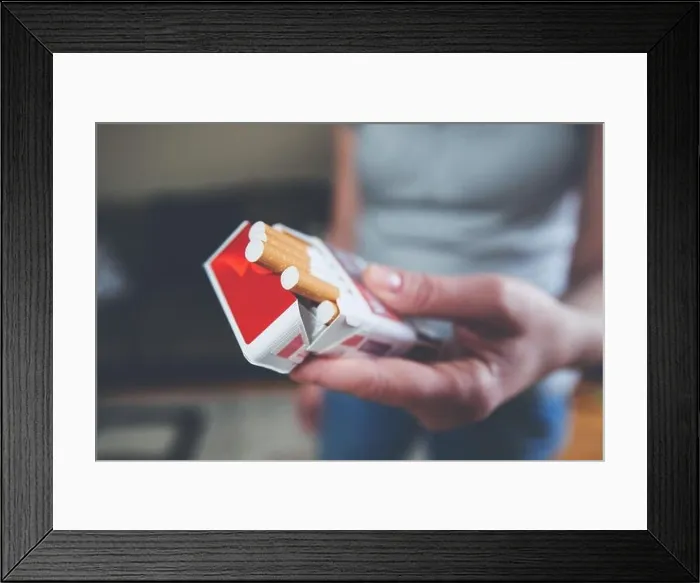Framed Print : Female hands hold pack of cigarettes, prepare for smoking cigarette, closeup, indoor