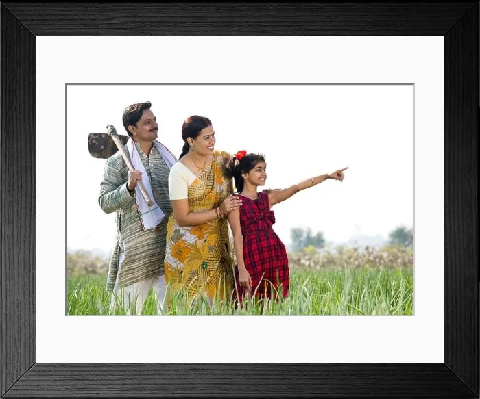 Framed Print : Happy Indian family in agricultural field looking away Framed Print : Happy Indian family in agricultural field looking away