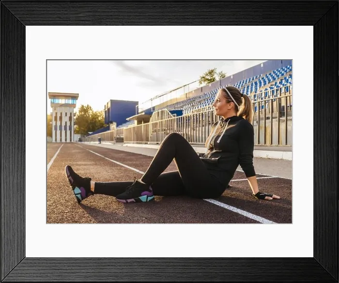 Framed Print : woman resting after running at the stadium Framed Print : woman resting after running at the stadium