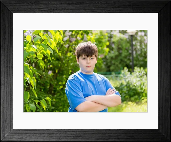Framed Print : The boy crossed his arms in summer park Framed Print : The boy crossed his arms in summer park