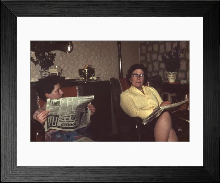 Framed Print : circa 1967 Two women reading newspapers in a typical living room in England Photograph by Tony Henshaw Framed Print : circa 1967 Two women reading newspapers in a typical living room in England Photograph by Tony Henshaw