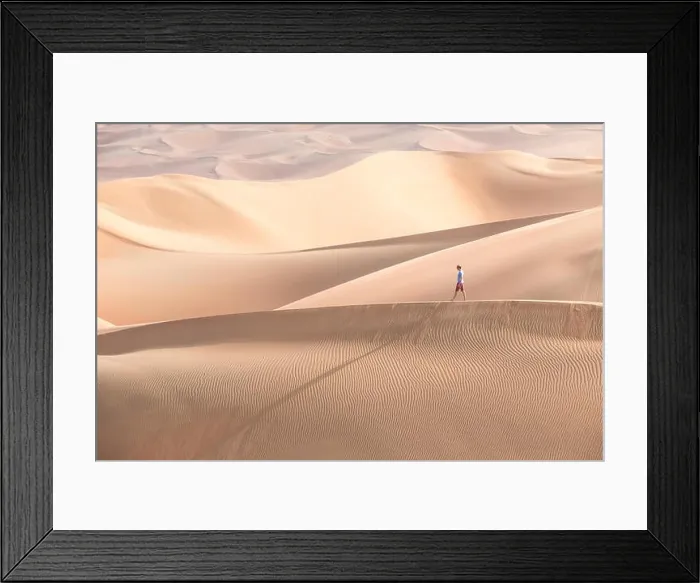 Framed Print : Young handsome caucasian tourist in shorts and straq hat hiking in Liwa desert dunes. Abu Dhabi, UAE Framed Print : Young handsome caucasian tourist in shorts and straq hat hiking in Liwa desert dunes. Abu Dhabi, UAE