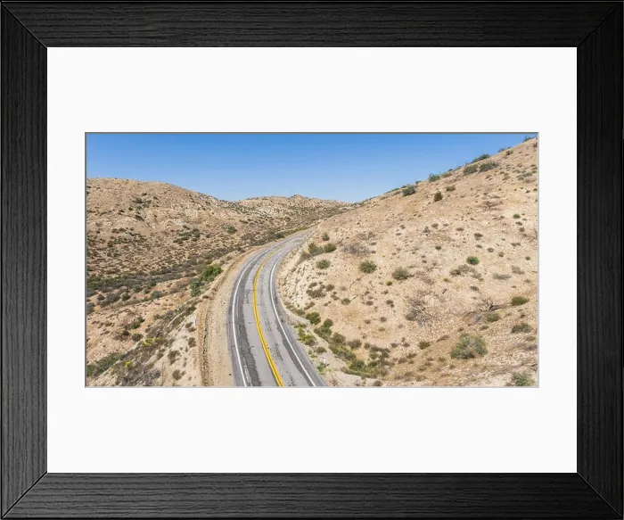 Framed Print : Bend in a desert road wrapping around a wilderness hillside Framed Print : Bend in a desert road wrapping around a wilderness hillside