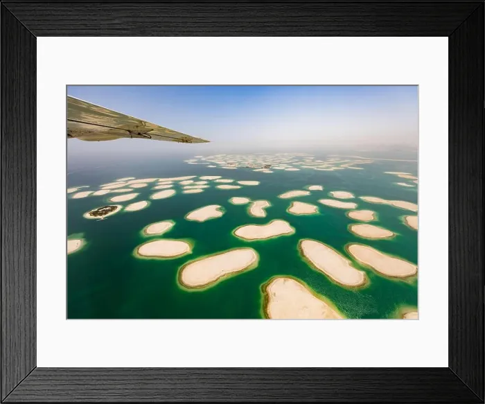 Framed Print : Aerial view from small airplane window, artificial palm island in Dubai. Panoramic view Framed Print : Aerial view from small airplane window, artificial palm island in Dubai. Panoramic view
