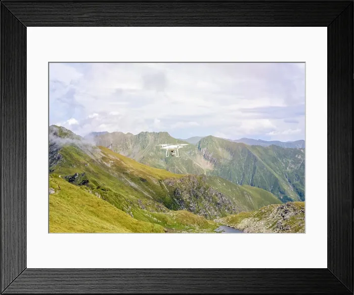 Framed Print : White drone flying in Fagaras Mountains, near Paltinului saddle. Bright sky with clouds on background. Romania Framed Print : White drone flying in Fagaras Mountains, near Paltinului saddle. Bright sky with clouds on background. Romania