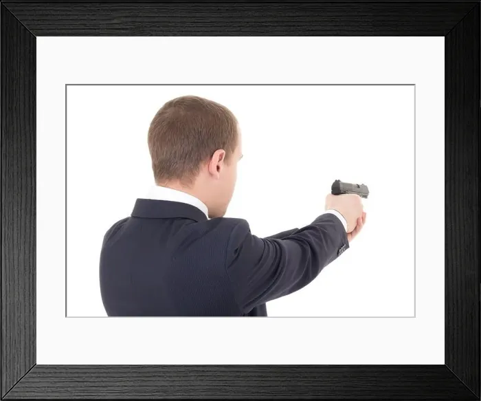 Framed Print : back view of man shooting with gun isolated on white background Framed Print : back view of man shooting with gun isolated on white background