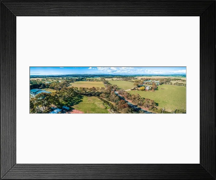 Framed Print : Aerial panorama of road, meadows and pastures on bright summer day in Australia Framed Print : Aerial panorama of road, meadows and pastures on bright summer day in Australia