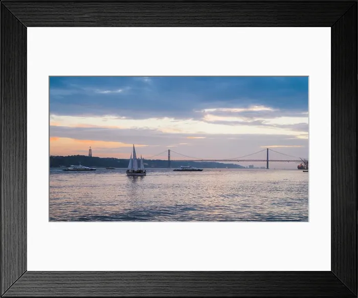 Framed Print : Lisbon, Portugal - Oct 23, 2018: Sunset on River Tagus, Lisbon, Portugal with 25 April Bridge in background and boats Framed Print : Lisbon, Portugal - Oct 23, 2018: Sunset on River Tagus, Lisbon, Portugal with 25 April Bridge in background and boats