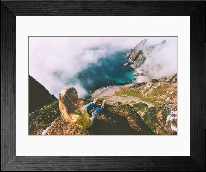 Framed Print : Summer vacations in Norway travel woman tourist relaxing alone on mountain cliff over ocean active lifestyle hiking
